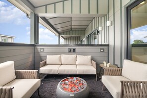 Unit 2: Covered private rooftop deck with a hot tub, lounge areas, fire pit, and access to the second living area. (4th Floor)