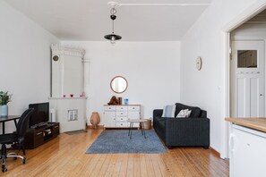 This spacious living room is the heart of the apartment—perfect for unwinding, working, or sharing a meal.