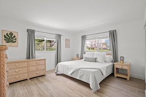 Secondary bedroom with a comfortable king bed in Unit 1.