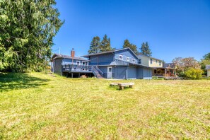 Partially fenced yard, deck and firepit, perfect for gathering with family and friends.