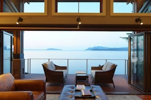 Main house: the main floor windows accordion open to join the living space & deck