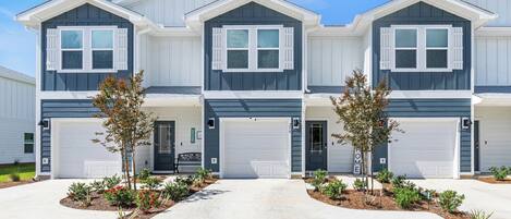Charming exterior of the townhome with a single-car garage