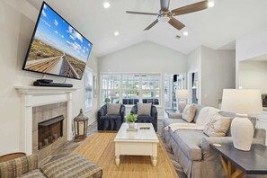 Bright living area with ample seating and Smart TV