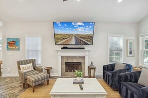 Bright living area with ample seating and Smart TV