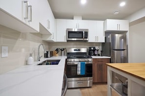 Well-equipped kitchen with sleek cabinetry and stylish modern touches.