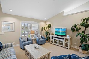 Professionally decorated living room with coastal decor. 
