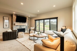 Family room with luxury furnishings and patio with hot tub
