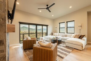 Main level living room with a private deck and views