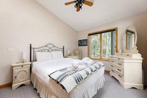 The warm colors and comfortable furnishings in this bedroom create a peaceful and welcoming atmosphere.