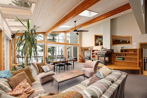 The perfect gathering spot! This bright and airy living room flows seamlessly into the dining area, all while providing a beautiful backdrop of the outdoors.