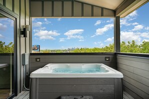 2nd Unit (4th Floor): The Covered Deck features a hot tub and BBQ grill, perfect for relaxing and outdoor dining with a view.