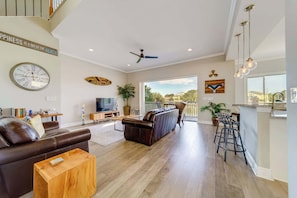 Gather, relax, and take in the view—this airy living area opens right onto the water-facing deck!