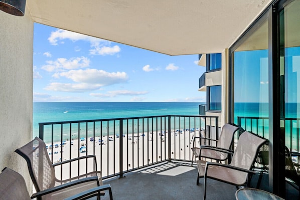 Take in the salty breeze and stunning beach views from your private balcony with comfortable seating.
