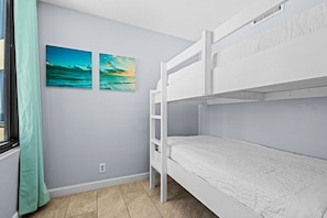 Enjoy natural light and breathtaking views from the bunk room, which includes an entrance door for added privacy just steps from the living area.
