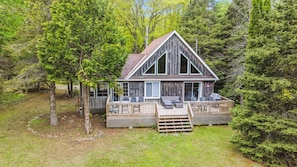 Gaze at the treetops or the lake from the impressive window-lined A-frame facade—designed to bring the beauty of the outdoors right into the living space.