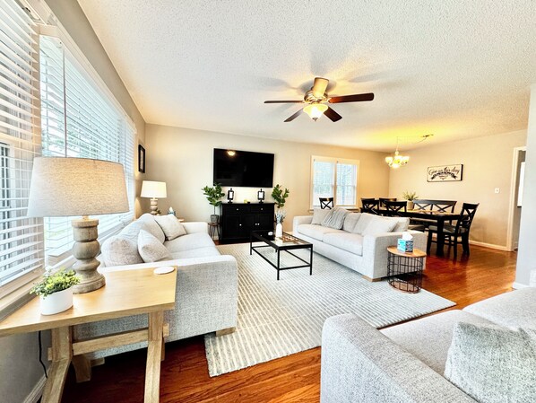 Cozy living room with three plush sofas & a smart TV! 