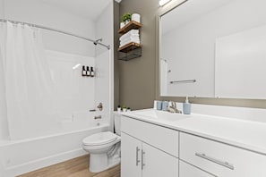 You feel a sense of calm as you enter the bathroom, where the thoughtful design and high-quality materials create a serene environment.