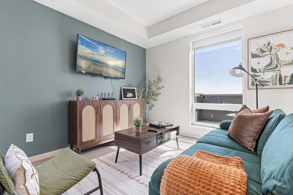 The living room’s cozy vibe makes it the perfect spot to relax, with ample seating and a warm ambiance.