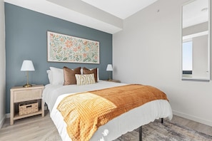 You feel enveloped in comfort as you relax on the queen bed, surrounded by a room designed for tranquility.