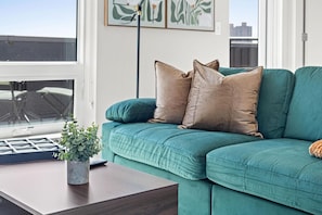 The living room’s cozy vibe makes it the perfect spot to relax, with ample seating and a warm ambiance.