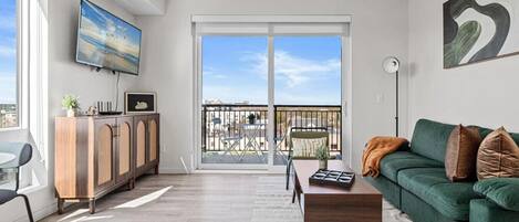 The living room is filled with natural light, creating a bright and welcoming space that invites relaxation.