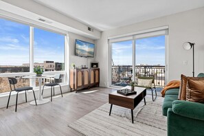 The living room is filled with natural light, creating a bright and welcoming space that invites relaxation.