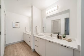 You feel a sense of calm as you enter the bathroom, where the thoughtful design and high-quality materials create a serene environment.