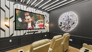 Newly renovated mickey-mouse themed in-home movie theater with large projector screen
