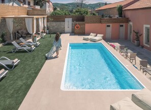 Shared exterior pool with plenty of sitting areas around it