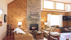 Living room with two separate seating areas and 55" TV.