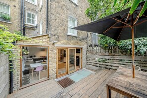 Ground floor - includes living area by the entrance and then the kitchen with dining table and the back terrace