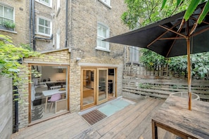 Ground floor - includes living area by the entrance and then the kitchen with dining table and the back terrace