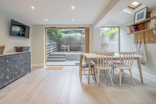 Ground floor - includes living area by the entrance and then the kitchen with dining table and the back terrace