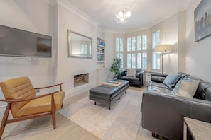 Ground floor - includes living area by the entrance and then the kitchen with dining table and the back terrace