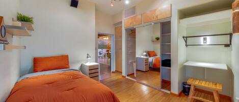 Bedroom 2 with single bed, closet, and access to one of the home's peaceful living room areas