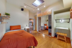 Bedroom 2 with single bed, closet, and access to one of the home's peaceful living room areas