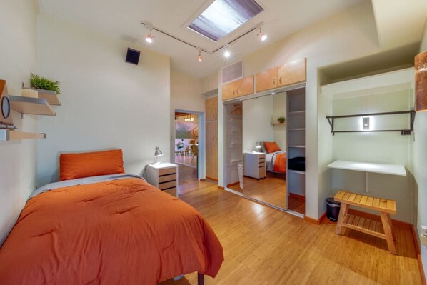 Bedroom 2 with single bed, closet, and access to one of the home's peaceful living room areas
