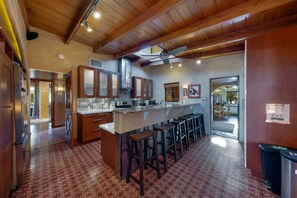 Large kitchen with abundant natural light and seating at the large peninsula