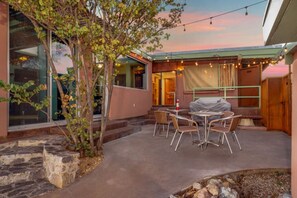 Patio 2 with shaded seating, lights, and gas grill
