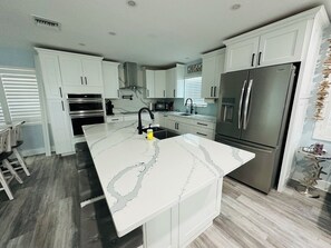 Large kitchen with 4 bar stools.