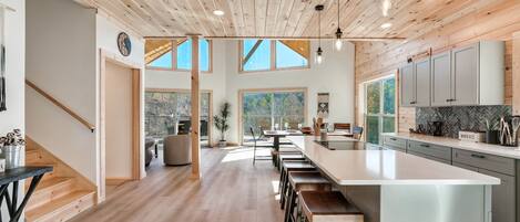 Open fully equipped kitchen with island that accommodates seating for 4