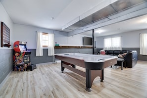 Game room with an arcade cabinet and air hockey—great for hours of entertainment and friendly competition.