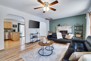 Family room with a spacious layout and a cozy fireplace—ideal for relaxing and spending quality time together.
