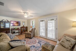 The living room comfortably seats 5 and is decorated with beautiful antiques