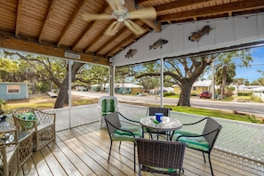 Large screened porch with dining and fan