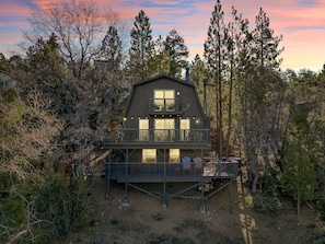 Nestled among the serene pines of Upper Moonridge, this meticulously redesigned cabin presents a unique fusion of sophisticated comfort and the splendor of nature.