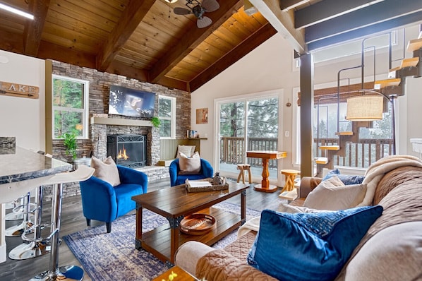 Bright, open living room with mountain views — perfect for summer mornings and game nights.