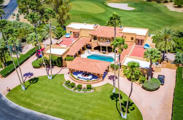 A stunning corner estate on the golf course that will leave you speechless! Featuring a circular driveway, 7-person jacuzzi, outdoor shower, snooker lounge, three spacious decks, and a private enclosed interior courtyard with a Roman-style heated pool—idea