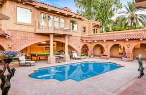 At the heart of the home lies a grand, palatial courtyard adorned with graceful mermaid fountains, majestic Grecian columns, and a luxurious Roman-style walk-in pool.