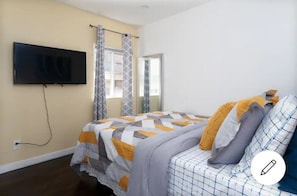 front house first bedroom with a queen bed